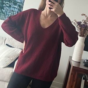 Red/burgundy V-neck sweater with cross-cross open back.